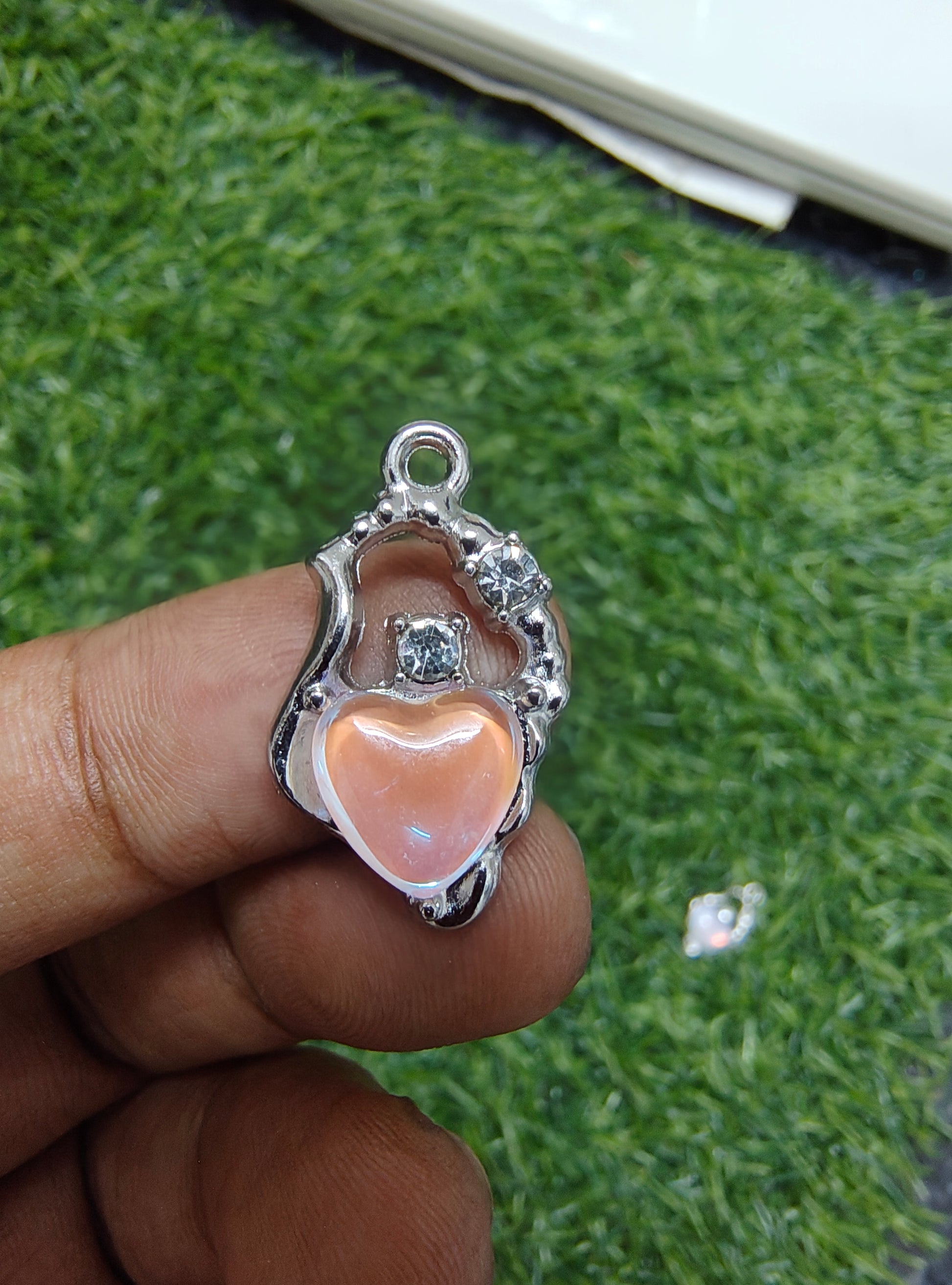 Stone charm with heart of different colour