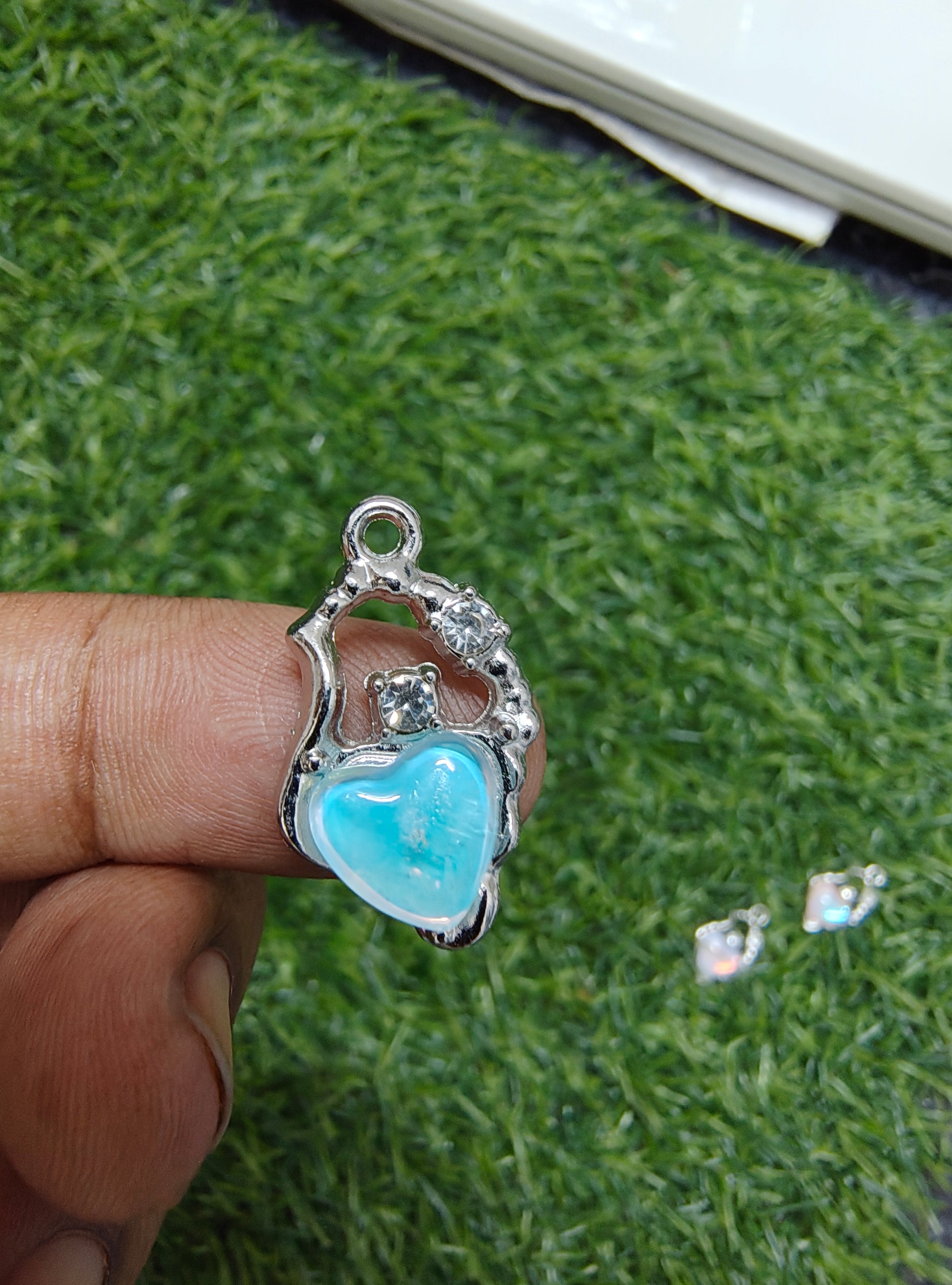 Stone charm with heart of different colour