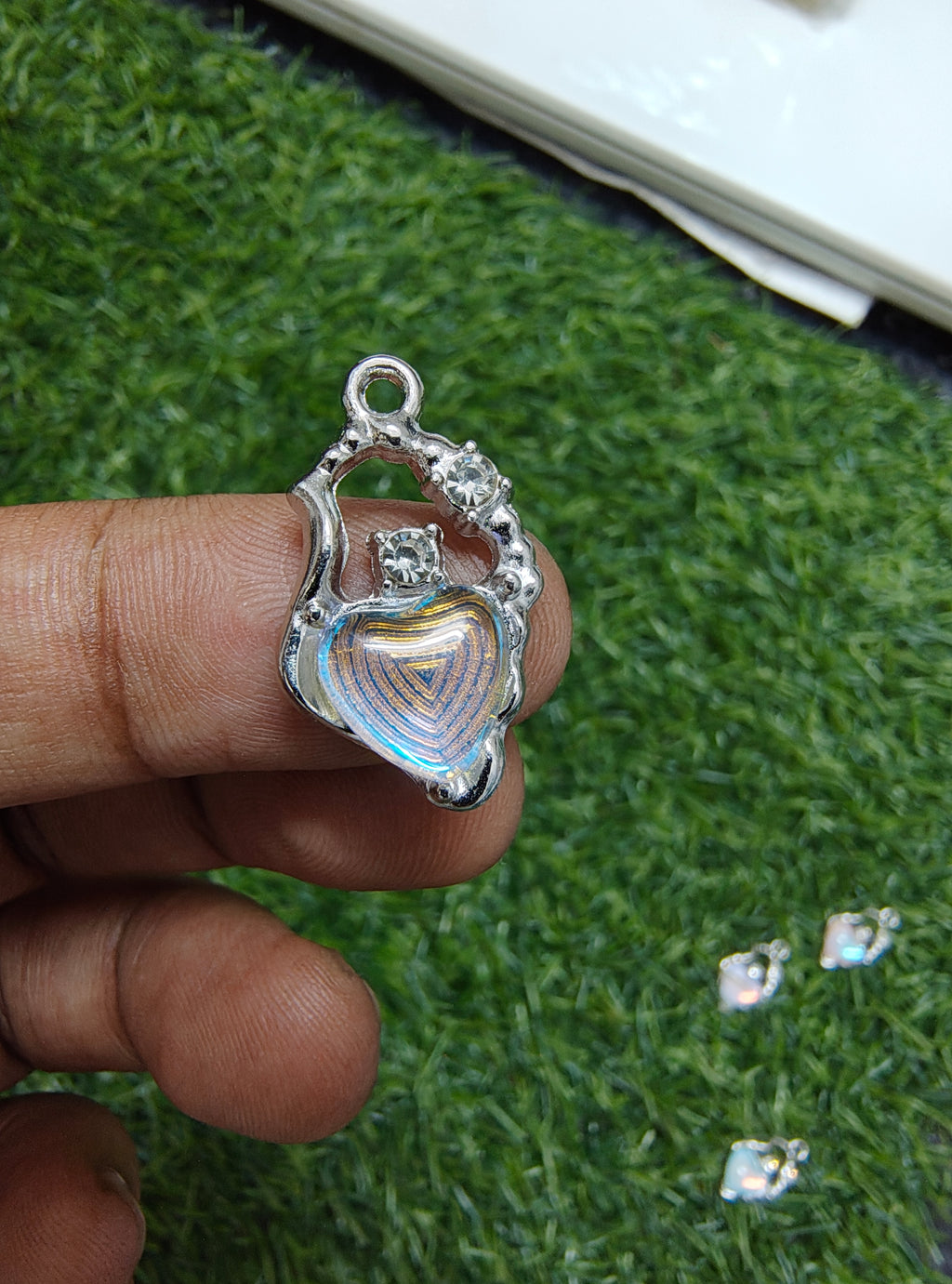 Stone charm with heart of different colour