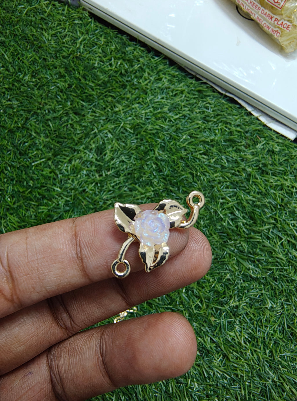 Rose in metal rakhi charm