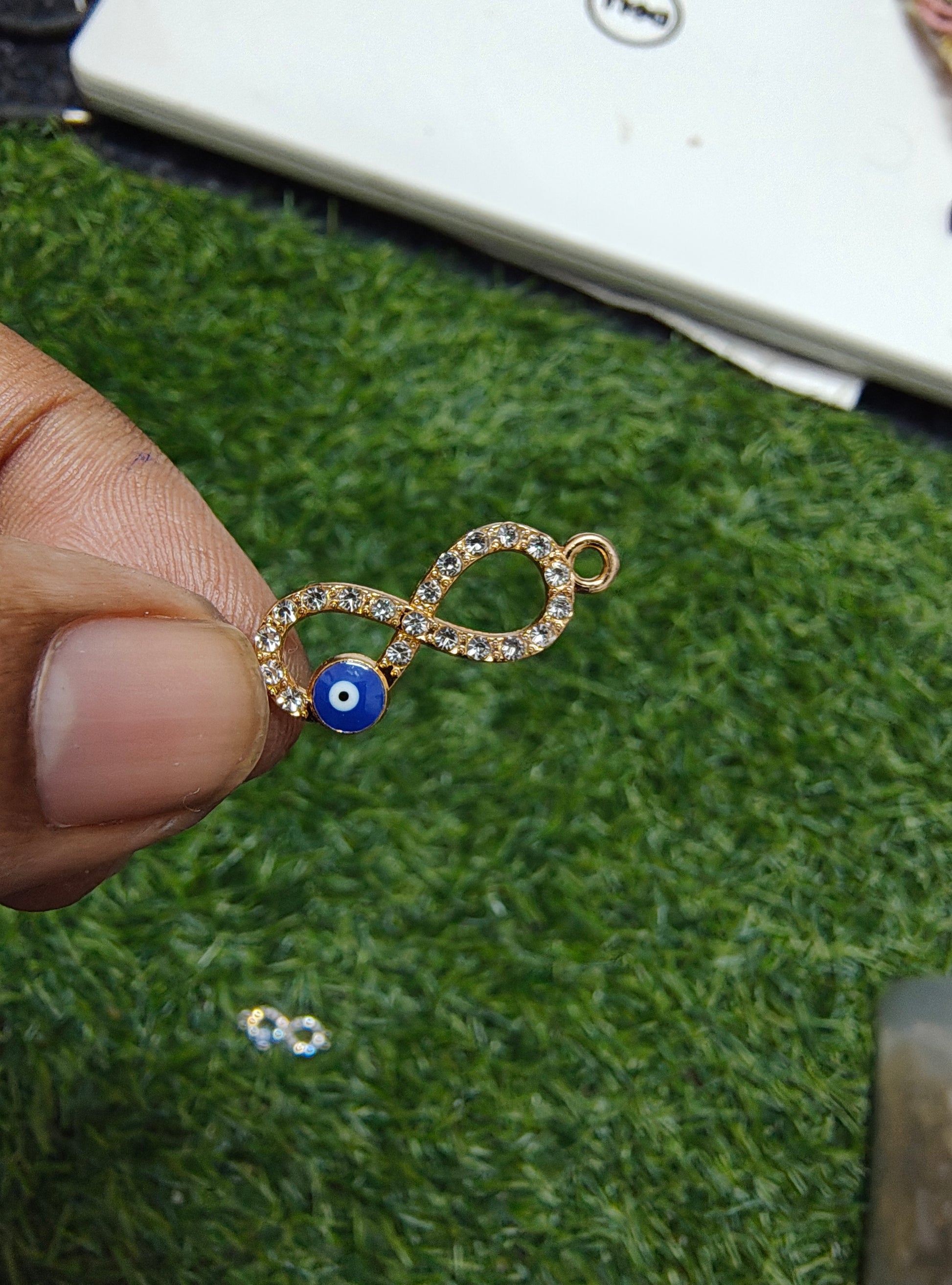 Infinity stone charm with evil eye